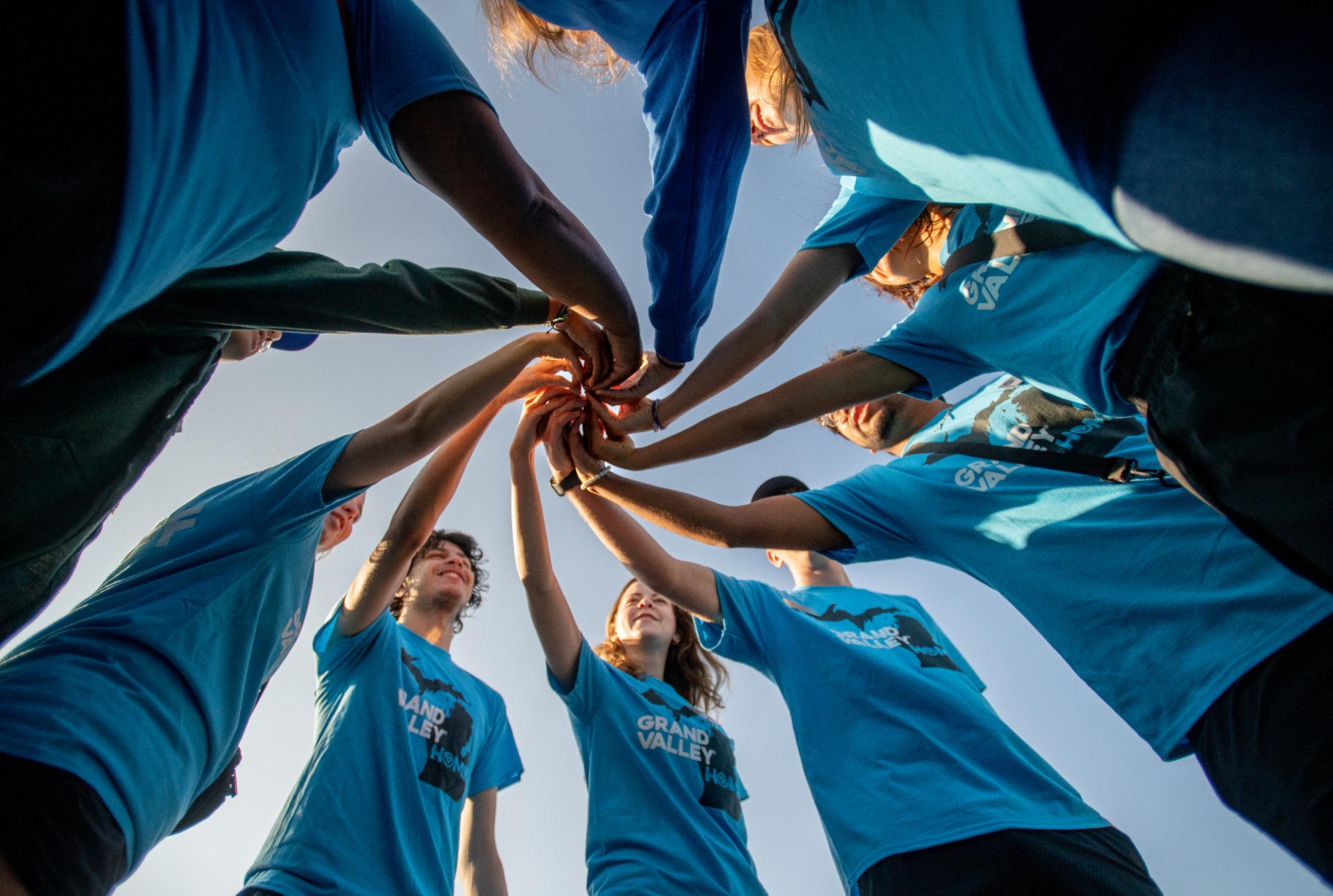 Group of students doing a handshake